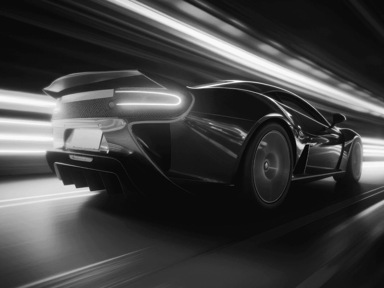 High-contrast black-and-white photograph of a sports car in motion, conveying speed and precision